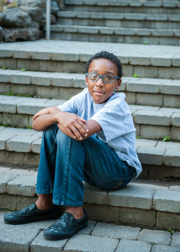 Young boy seated on staircase