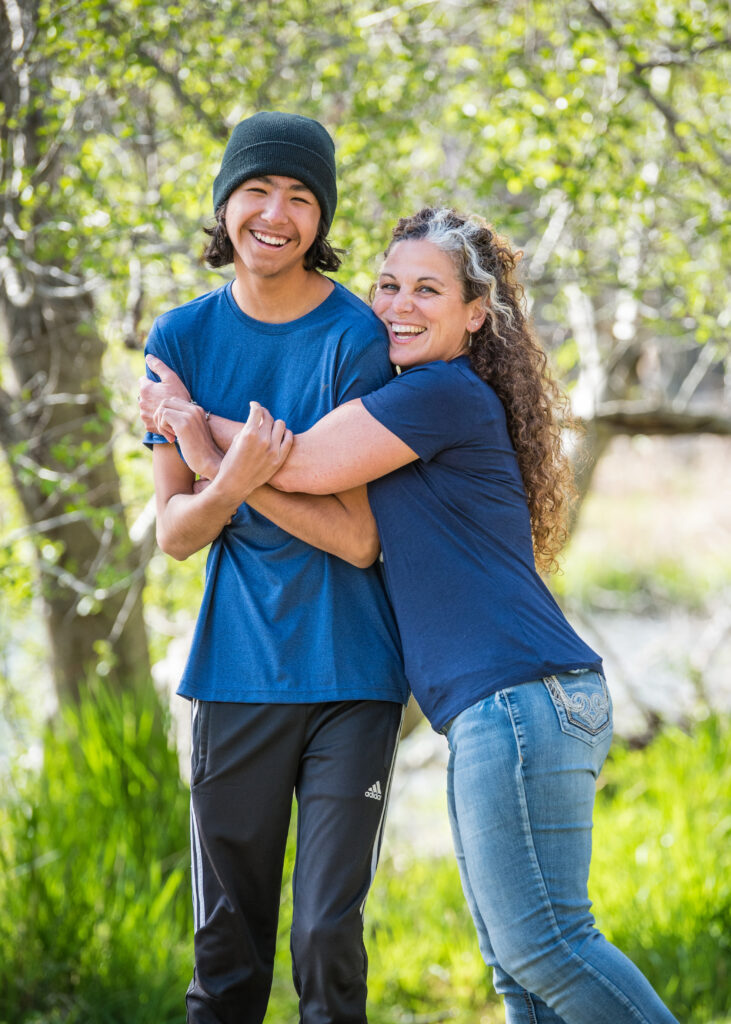 Two people laughing and hugging