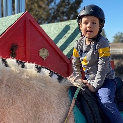 young boy riding a horse