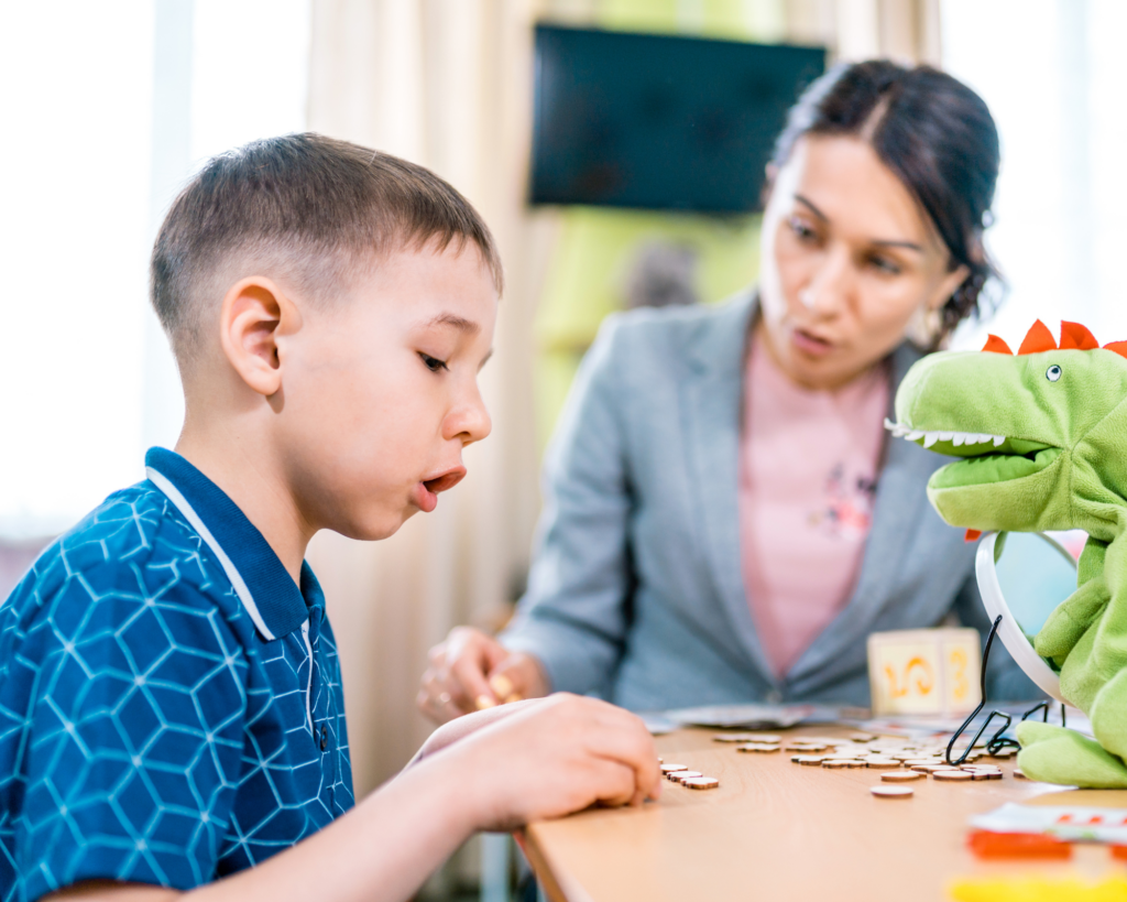 young woman training a young boy during speech therapy