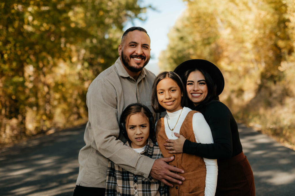 a family posing for a photo in a park