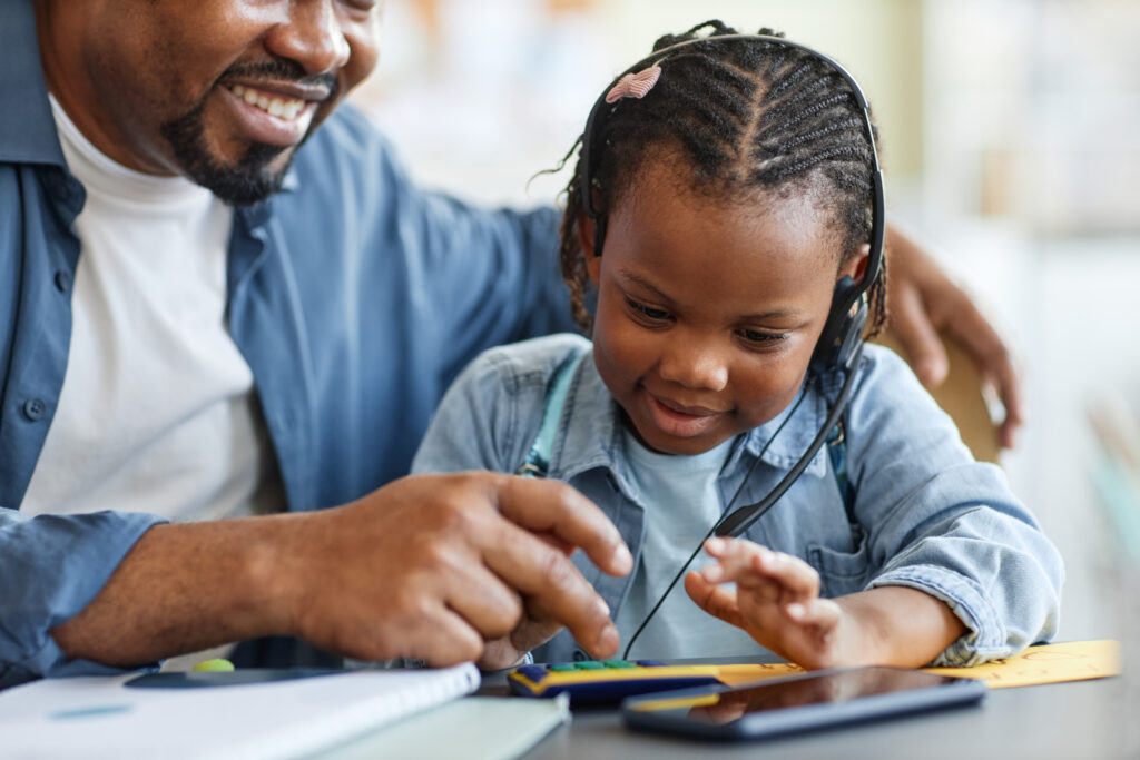 Portrait of caring of father and child playing with toy calculator learning to count together