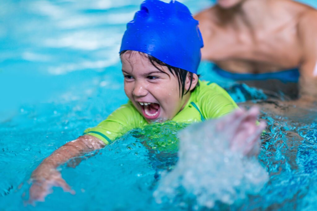 Excited little boy in a swimming pool